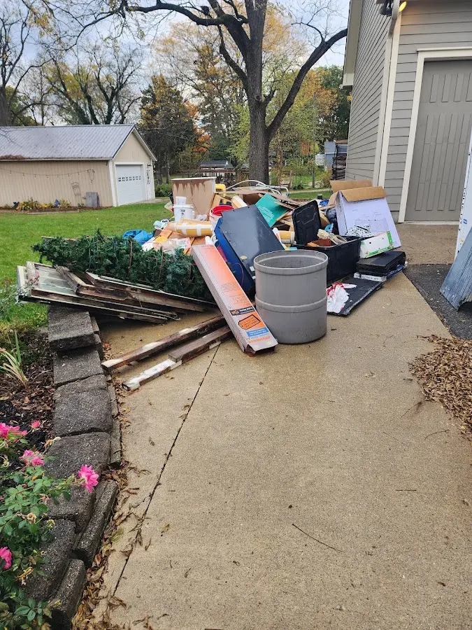 Dumpster being loaded with debris for Estate Cleanout Dumpster Rental in Rushville